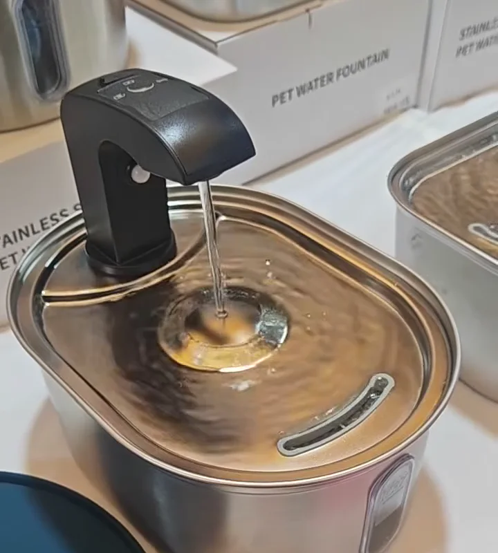 Classic stainless steel fountain flow landing on the raised central tray dome in real footage