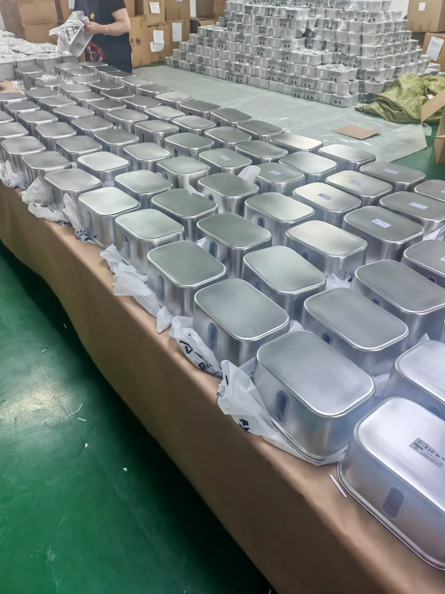 Unpacked square stainless steel fountain housings arranged on a worktable