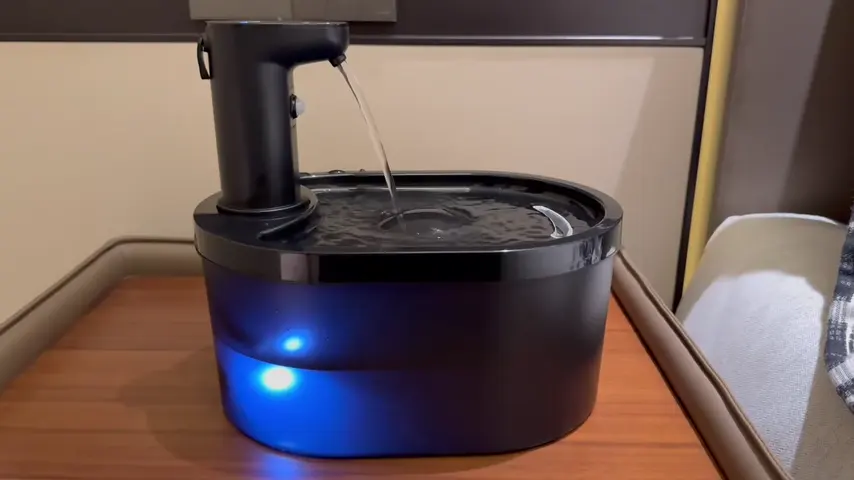 Black cordless plastic fountain positioned on a work surface