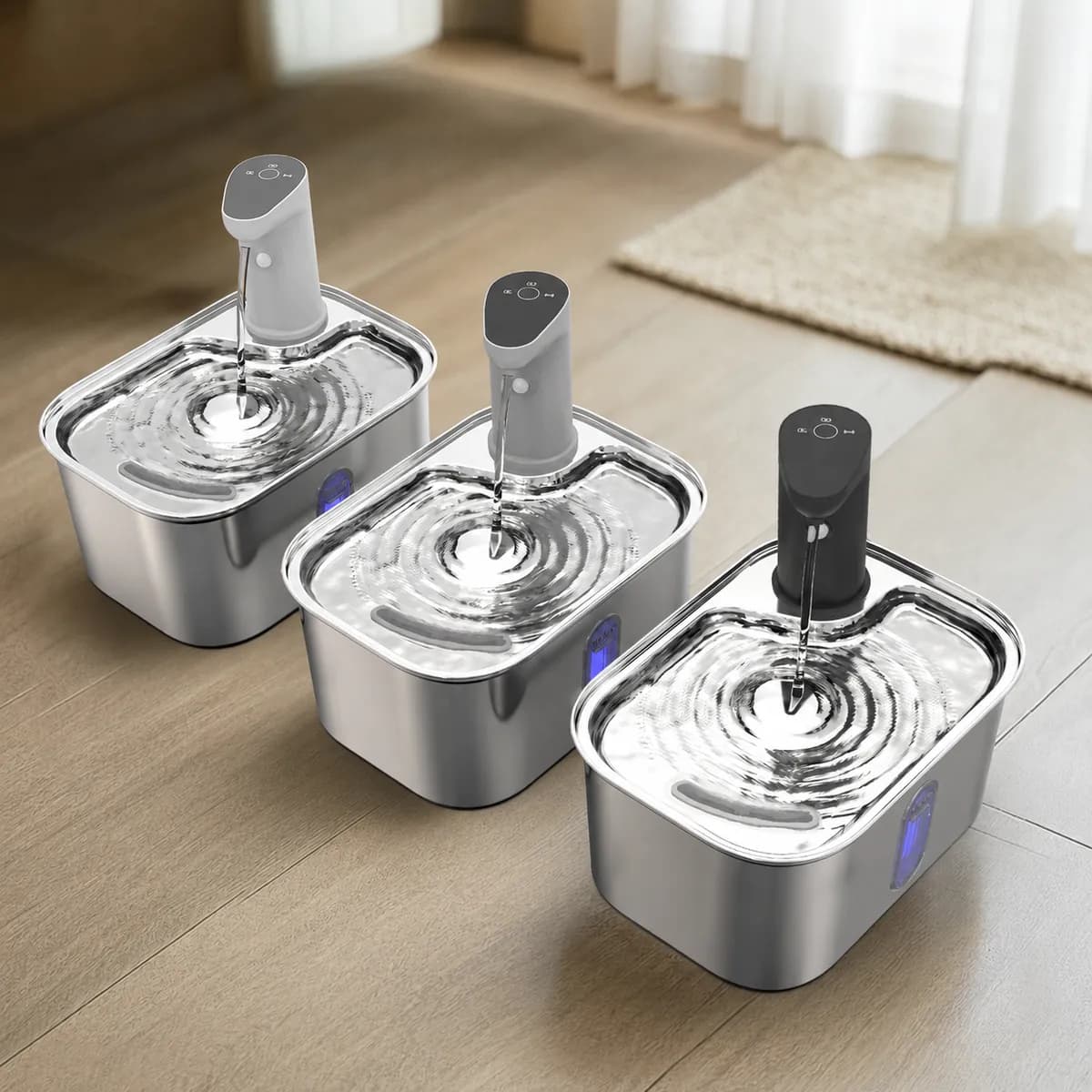 Three cordless stainless steel cat water fountains with white, gray and black outlet colors