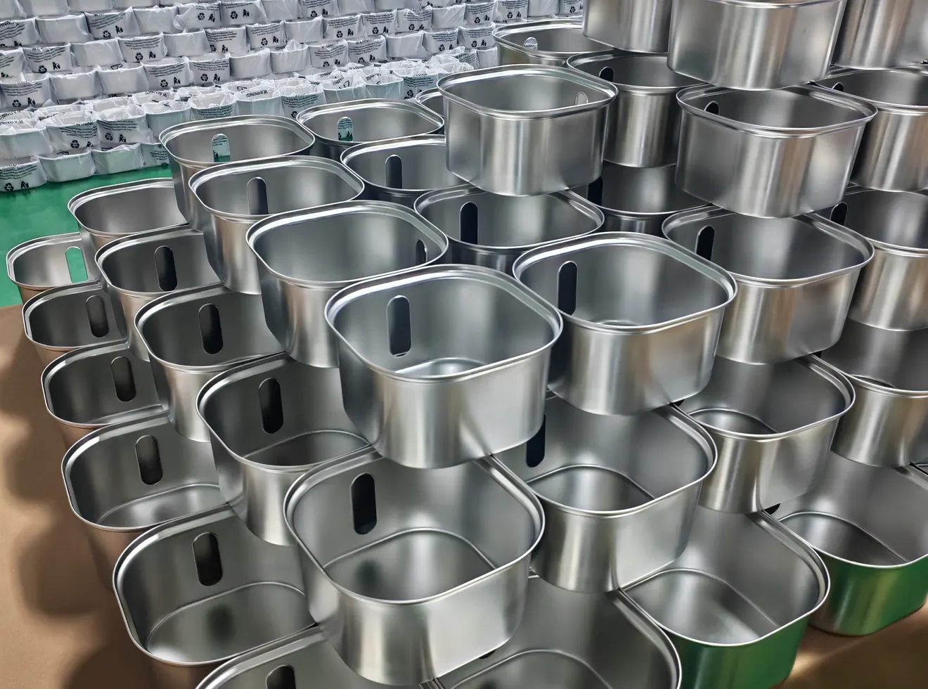 Stainless steel fountain housings staged for component preparation and packing