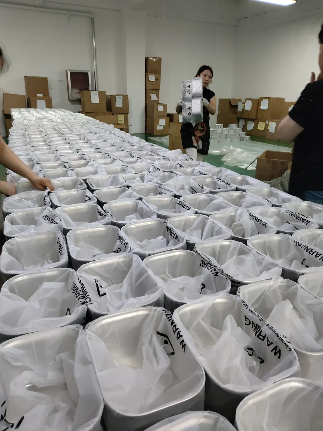 Wrapped stainless steel fountain bodies staged before packing