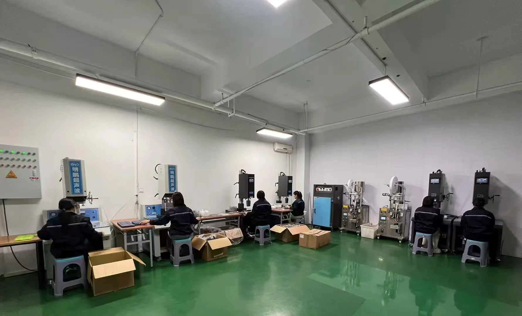 Workers operating ultrasonic equipment inside the Fountelio workshop