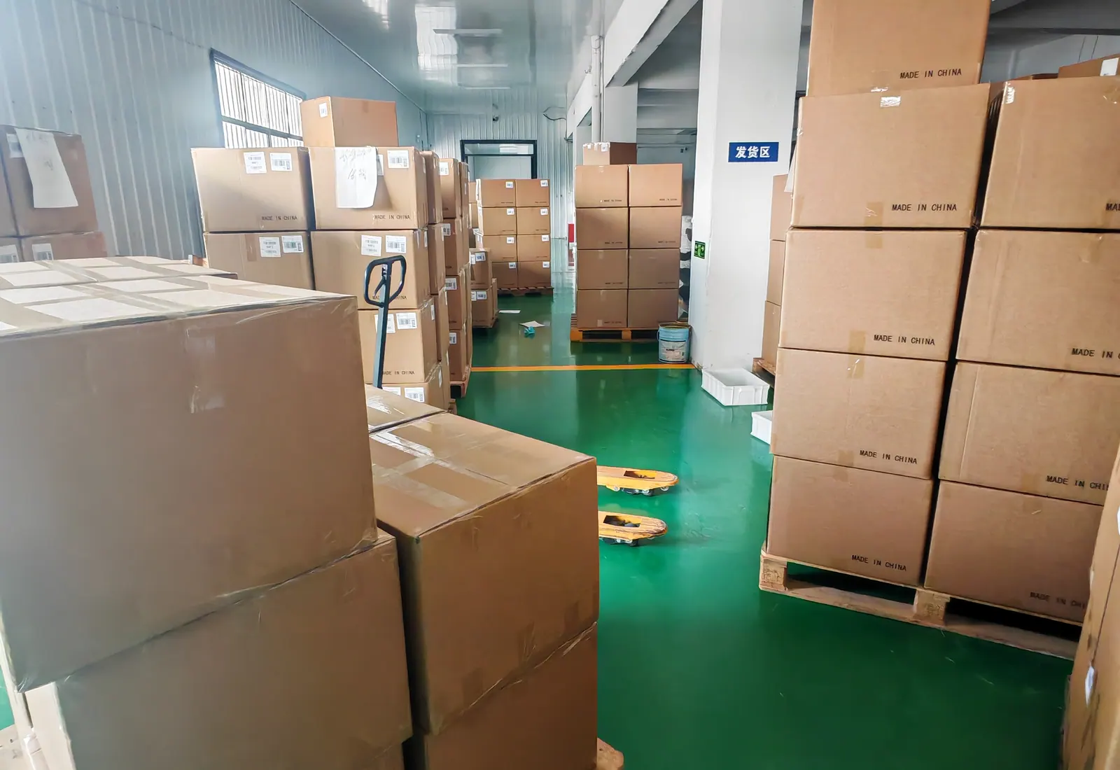 Palletized cartons arranged along a warehouse aisle before shipment