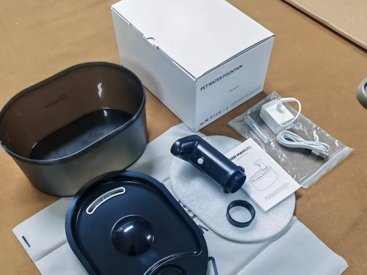 Fountelio fountain body, tray, outlet, manual, power parts and retail box arranged as a pack-out reference