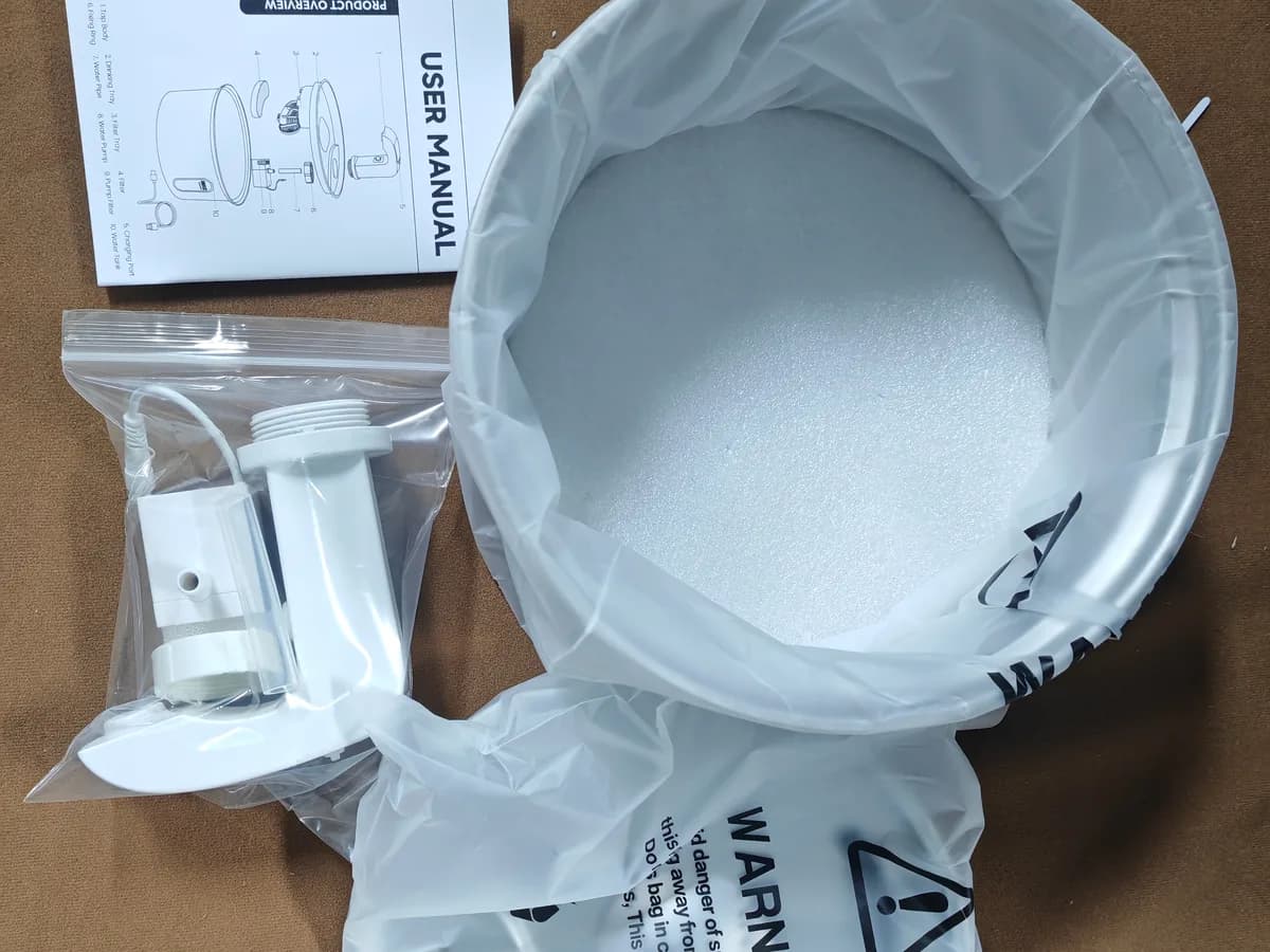 Protected stainless steel fountain body with foam pad, packed pump and outlet parts, and user manual
