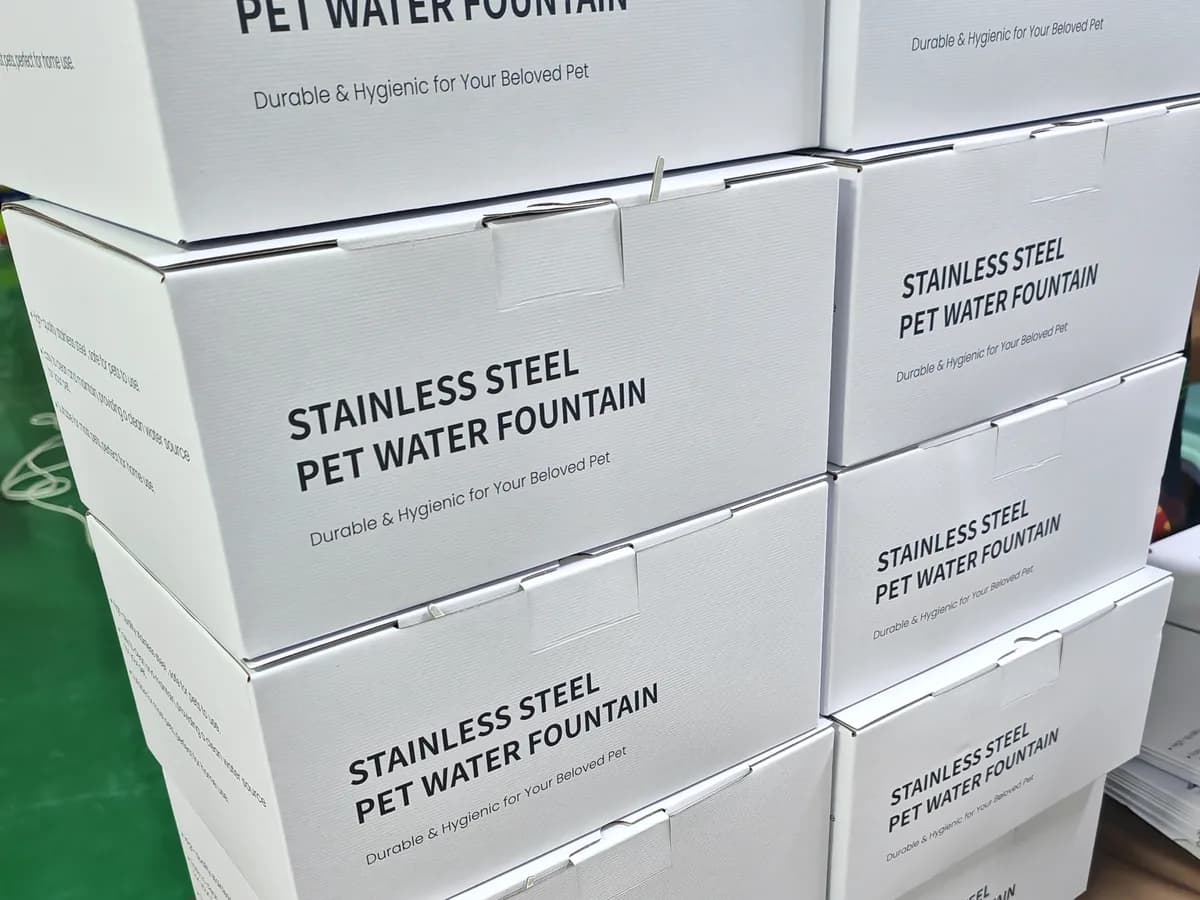 Printed stainless steel pet water fountain retail boxes stacked during packaging preparation