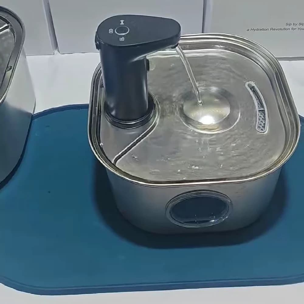 Square stainless steel cat water fountain with a black battery module and enlarged front window, photographed on a product display