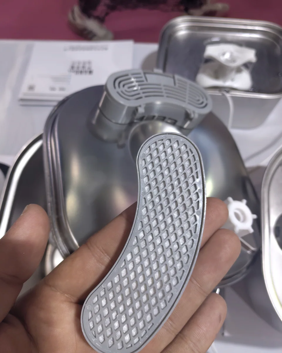 Crescent filter cartridge lifted from a Fountelio stainless steel cat water fountain during inspection