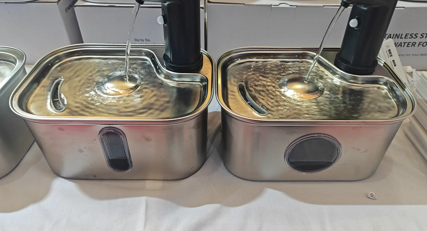 Two running Fountelio stainless steel fountains showing exposed trays, water outlets and reflective surfaces